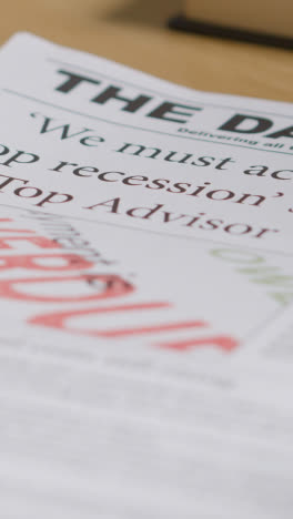 Vertical-Video-Of-Newspaper-With-Headline-On-Recession-Crisis-On-Home-Or-Office-Desk-2